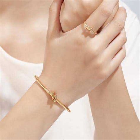 celine knot extra-thin bracelet in brass with gold finish|Women's Knot extra.